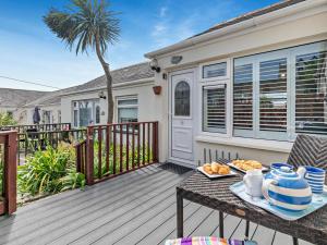 a table with a plate of food on a deck at 2 Bed in Helston oc-54556 in Mullion