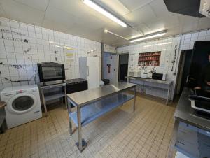 a laundry room with a table and a washing machine at Le CHALET in Gérardmer +24 photos