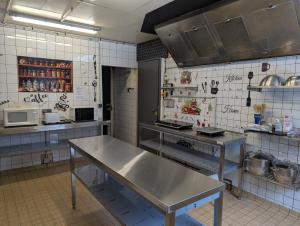 a kitchen with stainless steel tables in a kitchen at Le CHALET in Gérardmer