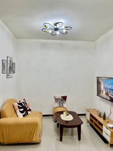 a living room with a couch and a table at Casa Ezeah Tagum Staycation in Tagum