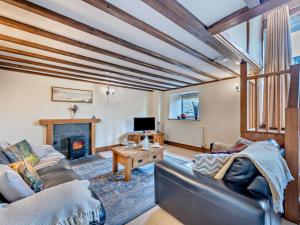 a living room with a couch and a fireplace at 2 Bed in Launceston oc-95236 in Saint Giles on the Heath