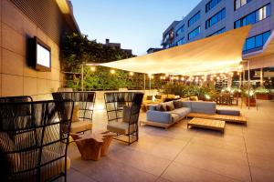 a patio with couches and chairs on a building at Hotel SB Icaria in Barcelona