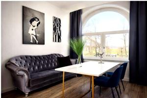 a living room with a couch and a table at VILLA BOWDY in Niederzier