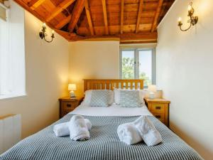 a bedroom with a bed with two pillows on it at 3 Bed in Launceston oc-88858 in Saint Giles on the Heath