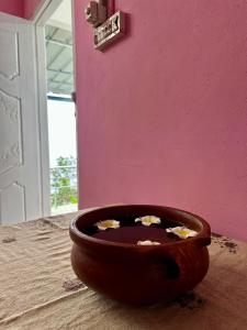 a wooden bowl filled with flowers on a wall at Misty Moutain view in Pīrmed +1 photo