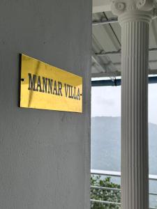 a sign on the side of a building with a column at Misty Moutain view in Pīrmed