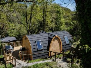 a wooden hobbit house with a deck and umbrella at 1 Bed in Padstow oc-77748 in Padstow