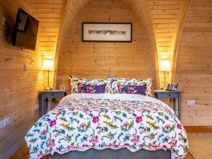 a bedroom with a bed in a wooden cabin at 1 Bed in Padstow oc-77748 in Padstow