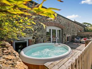 a jacuzzi tub on the deck of a house at 2 Bed in Launceston oc-92551 in Saint Giles on the Heath