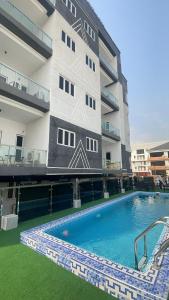 a building with a swimming pool in front of a building at Dephantom Continental Hotel in Lagos +53 photos