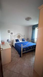 a bedroom with a bed with a blue comforter at Stella Marina in Olbia