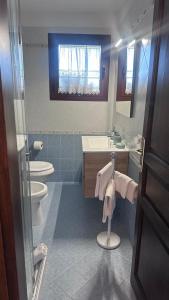 a bathroom with two toilets and a sink and a mirror at Stella Marina in Olbia +12 photos