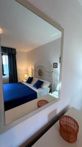 a reflection of a bedroom with a bed in a mirror at Stella Marina in Olbia