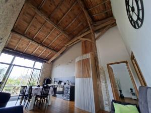 a living room with a clock on the wall at La Mirabelle in Montazeau +71 photos