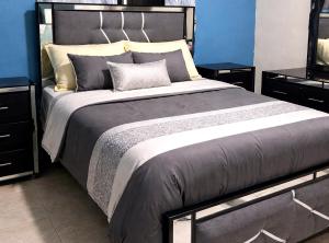 a large bed in a bedroom with blue walls at Villa Rosa in San Felipe de Puerto Plata