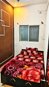 a large bed in a room with a window at Adiyogi Guest House in Ujjain