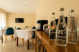 two empty bottles on a counter in a room at Kululwa House in Luanda
