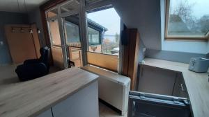 a small kitchen with a counter and a window at Ferienwohnung Seeblick in Wustrow