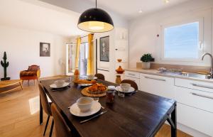 a kitchen and dining room with a table and chairs at Apt le Nid in Tourrettes-sur-Loup +15 photos