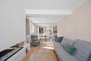 a living room with a couch and a table at Summer Dream in De Haan