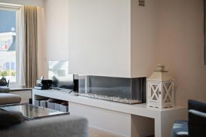 a living room with a kitchen with a stove at Summer Dream in De Haan