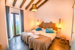 a bedroom with two beds and a large window at Espectacular casa rural en el corazón del Baztán in Ziga