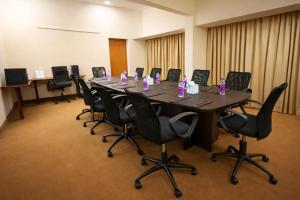 a large conference room with a long table and chairs at Hotel Saj Luciya in Trivandrum