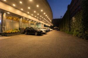 a row of cars parked in a parking lot at Hotel Saj Luciya in Trivandrum