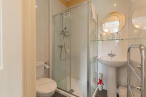 a bathroom with a shower and a toilet and a sink at The Ardyne Guest House in Rothesay +50 photos