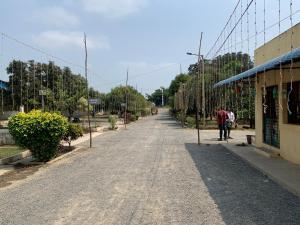 an empty street with people walking down the street at Amaravathi Convention & Function hall in Penuganchiprolu