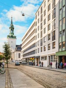 a city street with a building and a clock tower at Prime Location - 2 Bedroom Apartment! in Bergen
