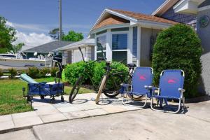a bike parked next to two chairs in front of a house at PrivateTropical Oasis in Jax Beach in Jacksonville Beach
