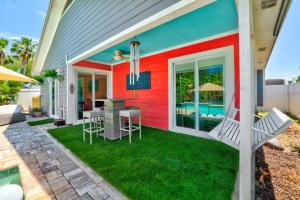 a colorful house with a patio with a table and chairs at PrivateTropical Oasis in Jax Beach in Jacksonville Beach