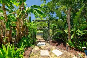 an entrance to a garden with a metal gate at PrivateTropical Oasis in Jax Beach in Jacksonville Beach