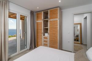 a bedroom with a view of the ocean at Endless Blue Anesea House in Provatas