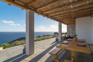 a patio with a table and a view of the ocean at Endless Blue Anesea House in Provatas