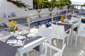 a table and chairs on the balcony of a building at RK Beach Hotel in Kamari