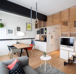 a living room with a couch and a table at Zoku Amsterdam in Amsterdam