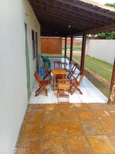 a patio with a table and chairs on it at BELL MAR CHALéS 05 in Luis Correia