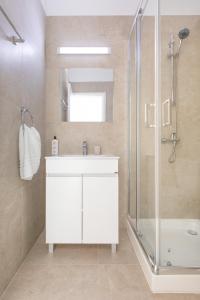 a bathroom with a white sink and a shower at 4YOU STUDIOS in Larnaca +32 photos