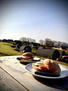 two plates of bread sitting on a wooden table at The Vu Snugs in Bathgate
