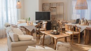 a living room filled with furniture and a flat screen tv at Apartmány U Petry in Luhačovice