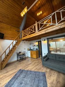 a living room with a couch and a staircase at Ağaran Duru Konak Suit Bungalov in Rize