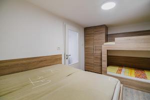 a bedroom with two beds and a bunk bed at Apartment Kamrca na Kopah in Šmartno pri Slovenj Gradcu