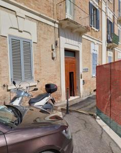 a motorcycle parked on a street in front of a building at B&B Domvs tva in Chieti