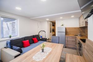 a living room with a couch and a table at Apartment Kamrca na Kopah in Šmartno pri Slovenj Gradcu +12 photos