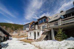 a house with snow on the ground in front of it at Apartment Kamrca na Kopah in Šmartno pri Slovenj Gradcu