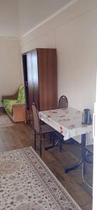 a room with a table and chairs and a couch at Лазурит in Tamga +15 photos