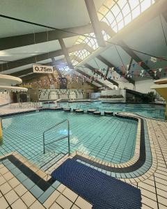a large swimming pool in a large building at Cornwall Countryside Lodges "Reserve Worldwide" Honicombe in Gunnislake