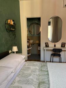 a bedroom with a bed and two mirrors at Stay & Solution Apartment in Trieste